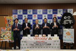 市長とセブンイレブンジャパンのみなさんがおにぎりを持って並んでいます